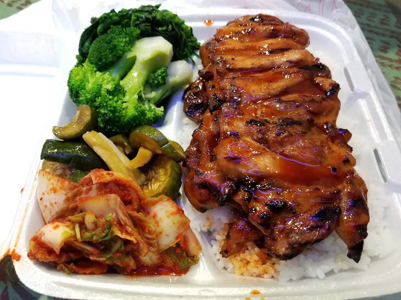 BBQ chicken plate with rice and sides