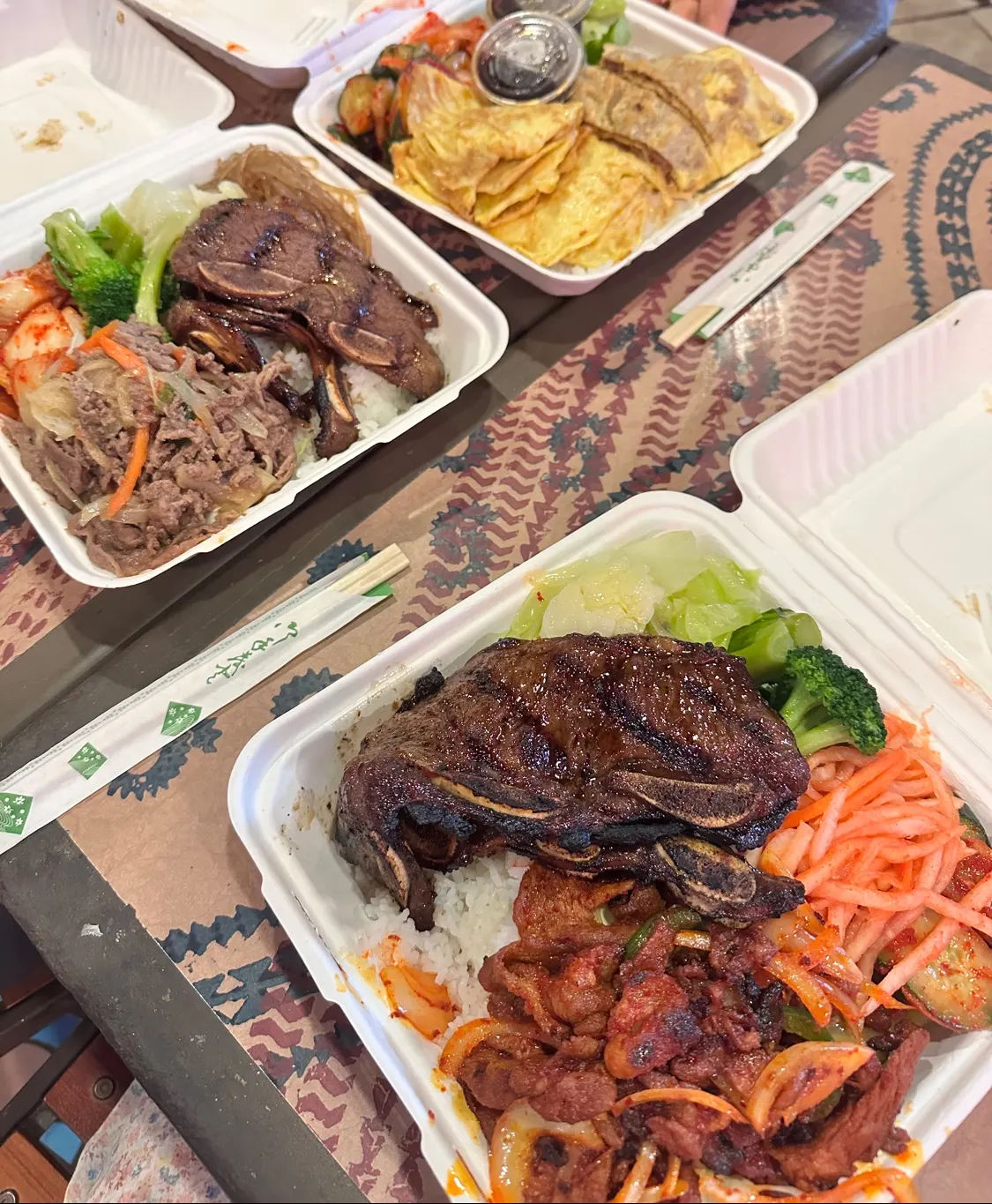 Two bulgogi plates with rice and sides